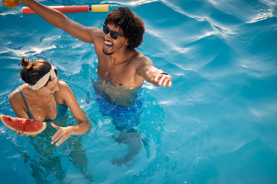 Multiracial couple on pool party, celebration vacation.