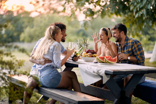 Group of cheerful friends having  at party outdoor .