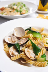 A Dish Of Fried Clams, Cucumber Slices And Fusilli Pasta