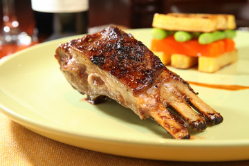 A Plate Of Roasted Pork Ribs With BBQ Sauce