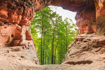 Famous Genovevahöhle photographed from the inside out is a cave of red sandstone and has served as...