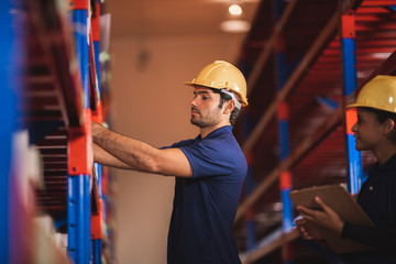 Male warehouse worker working for check and analyze newly arrived goods for further placement in storage department. Employee organizing goods distribution to the market