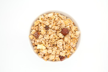 Bowl of whole grain muesli isolated on white background