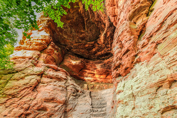 Inside with steep staircase of famous Genovevahöhle a cave of red sandstone as shelter for...