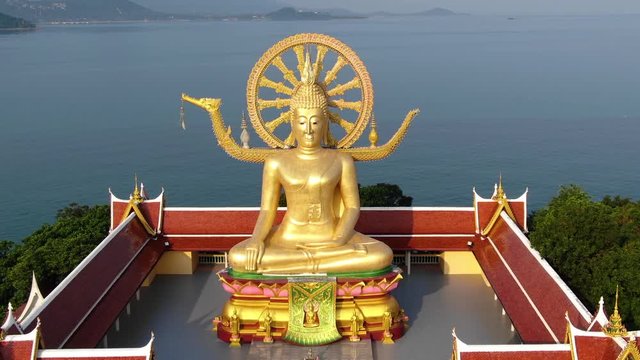 Thailand landmark. Aerial view of golden Buddha statue of the Big Buddha temple with sea on background in Koh Samui