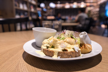 Substantial breakfast with fried egg, salad, bread and coffee, top view