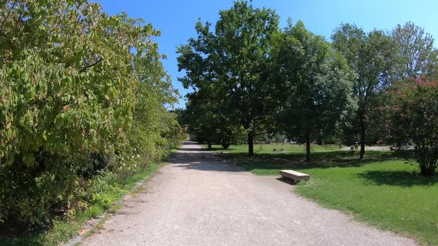Pavia, Italy - August 13, 2020: 4K moving time lapse walking through the park and towards the Visconti Castle of Pavia