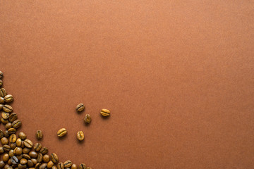 Fototapeta na wymiar Coffee beans on brown background close up