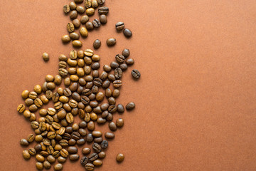 Coffee beans on brown background close up