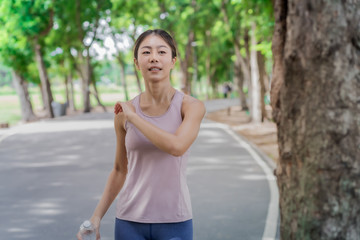 Young woman doing running exercises in the park.