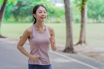 Young woman doing running exercises in the park.