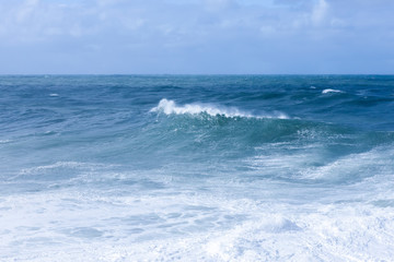 Naklejka na ściany i meble Foamy stong waves crashing in the ocean