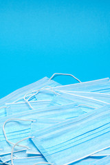 Disposable blue medical face mask on blue background