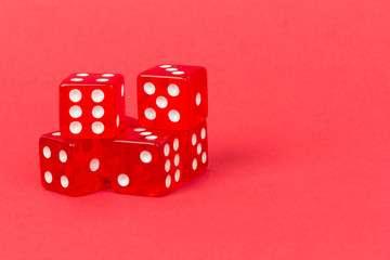 Transparent and red glass dices isolated on red background.