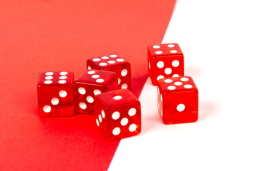 Transparent and red glass dices isolated on red and white background.