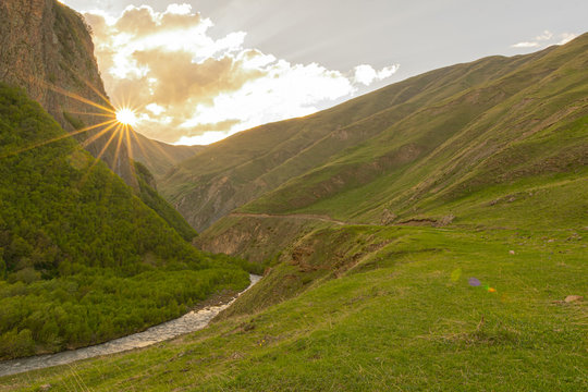 Old military road to Truso valley in Kazbegi national park. Sureal and beautiful green landscapes of caucausus.Scenic roads of Georgia