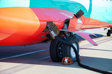 Refueling the plane. Filling tank and gun. Fuel supply through a hose. Weel.