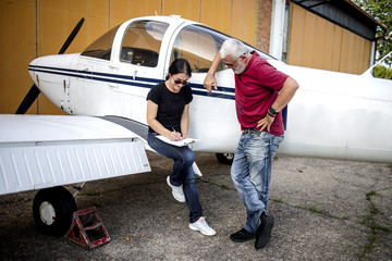 The older couple prepares to fly in a smaller airport with good fun and laughter