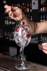 The bartender prepares a cocktail in the restaurant bar. The process of pouring alcohol into a glass.