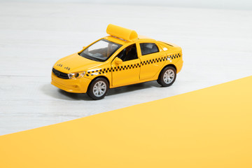 Yellow taxi on a light background. Taxi