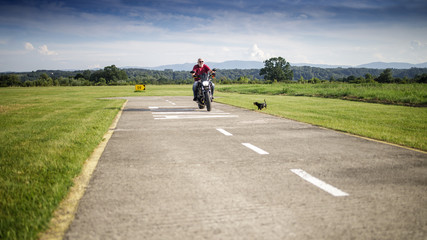 Fototapeta premium A middle-aged man hawe fun with his motorcycle and odg