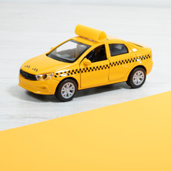 Yellow taxi on a light background. Taxi