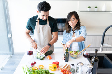 Young Couple Preparing Food In Kitchen