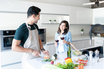 Couple Having Wine While Preparing Food