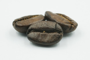 Three coffee beans isolated on white background.