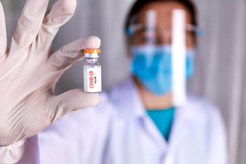 Covid-19 coronavirus vaccine Close up hands of scientist show Covid-19 vaccine in glass vial Hands of doctor wear latex glove holding Covid-19 vaccine in glass vial Healthcare and medical concept