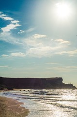 sunset on the beach blue sky with clouds above the sea
