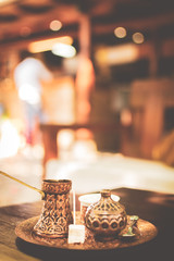 Turkish coffee set up candy with toothpick in Bosnian restaurant with weiter at the bar. Tourism...