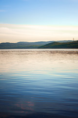 landscape of the river with green background and reflections in water