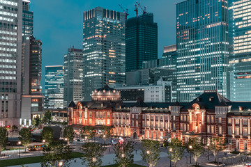 Fototapeta premium Beautiful urban cityscape with Tokyo station under twilight sky and neon night in Marunouchi business district, Japan
