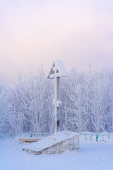 winter landscape wooden cross in snow with trees