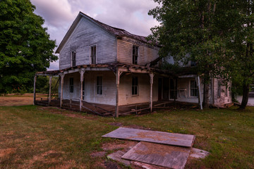 A late evening view of an abandoned cottage in the Catskill Mountains of New York.