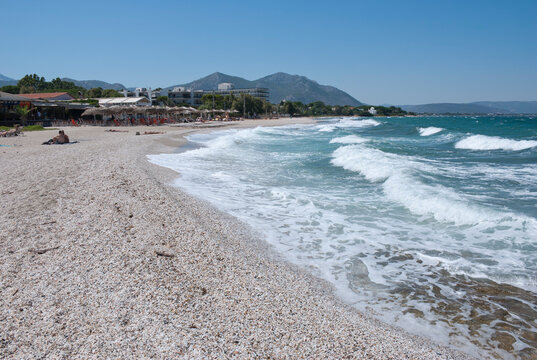 Athens, Greece, August 2020: Beautiful pebbled beach and stormy sea waters