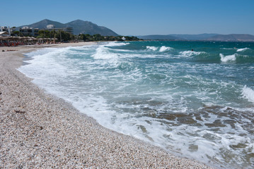 Athens, Greece, August 2020: Beautiful pebbled beach and stormy sea waters
