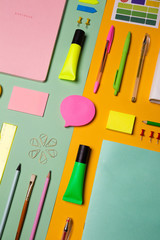 School tools and accessories on yellow and light green background