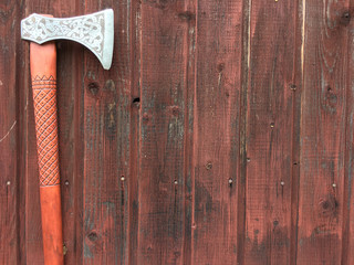 an axe on a background of brown boards