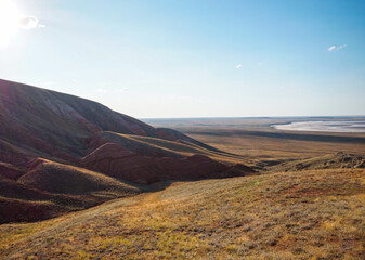 Big Bogdo mountain. Red sandstone outcrops on the slopes sacred mountain in Caspian steppe Bogdo -...