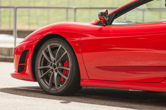 A Red Luxury Sports Car At Outdoors