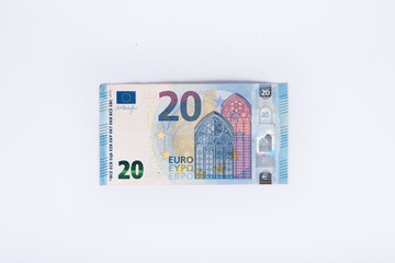 one banknote and money, in euros, close up on white background. Business and financial concept,...