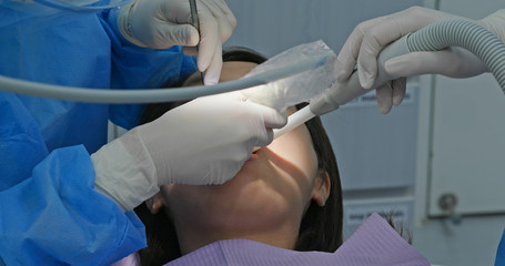 Woman undergo dental scaling treatment