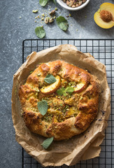 Appetite summer peach galeta on white table with copy space. summer open tart