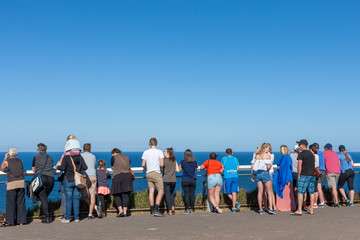 Byron Bay, Australia - June 2, 2016: Tourists and visitors of Cape Byron Lighthouse enjoying the ocean view from the high viewpoint