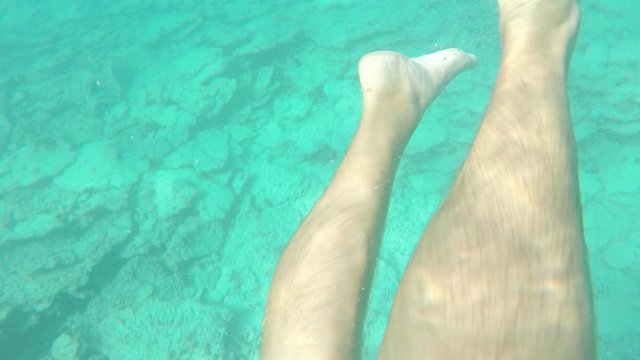 man diving and swiming underwater with seabob 