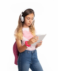 Girl with backpack listening to music and looking at tablet