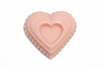 Heart-shaped pink handmade soap isolatd on white background, close up