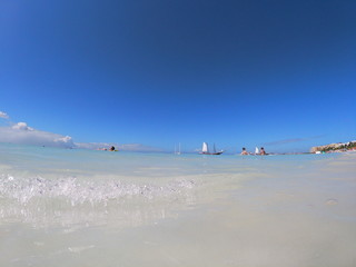 White sand beach with a clear wave. Aruba beach. Blue sky. Aruba summer